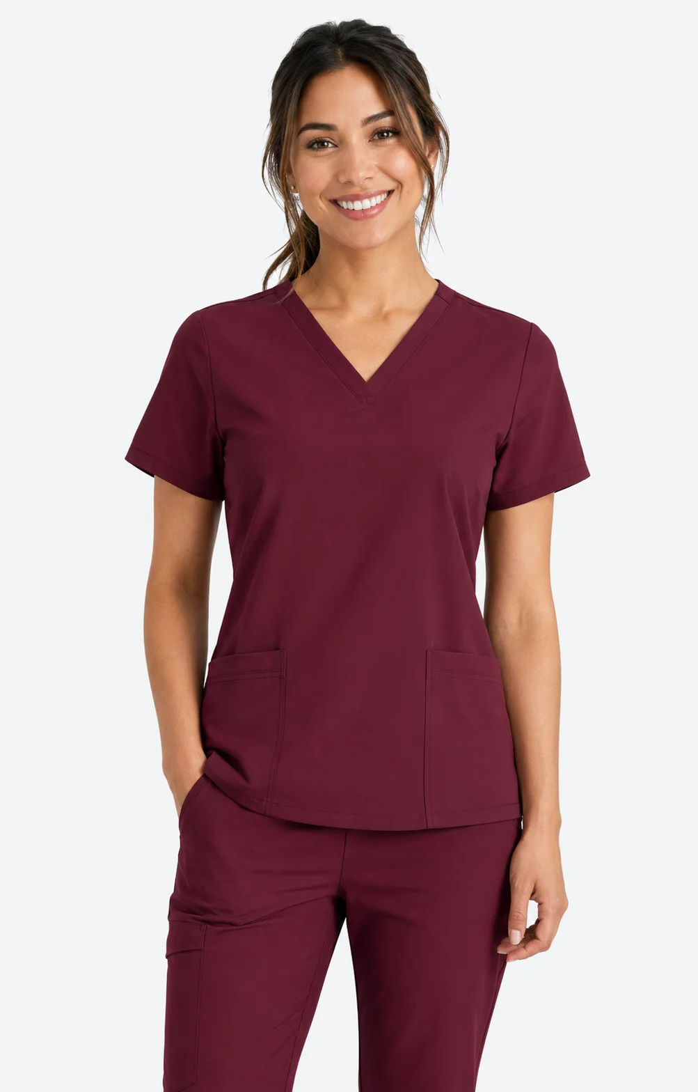 Female healthcare professional wearing burgundy medical scrubs
