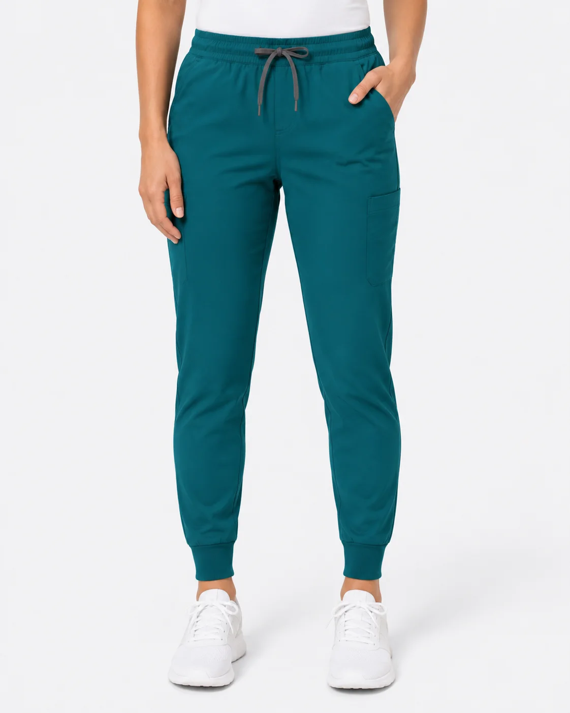 Teal jogger scrub pants with cuffed ankles and white sneakers